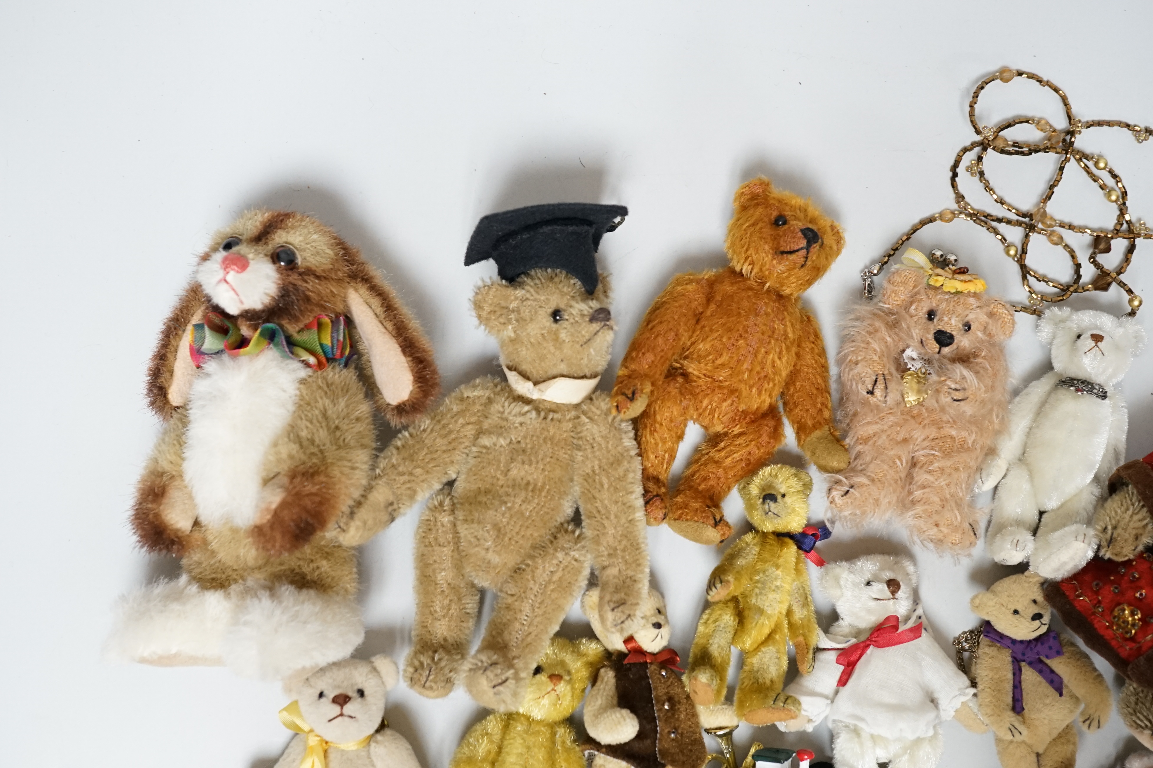 Twelve miniature American artist's bears and one rabbit